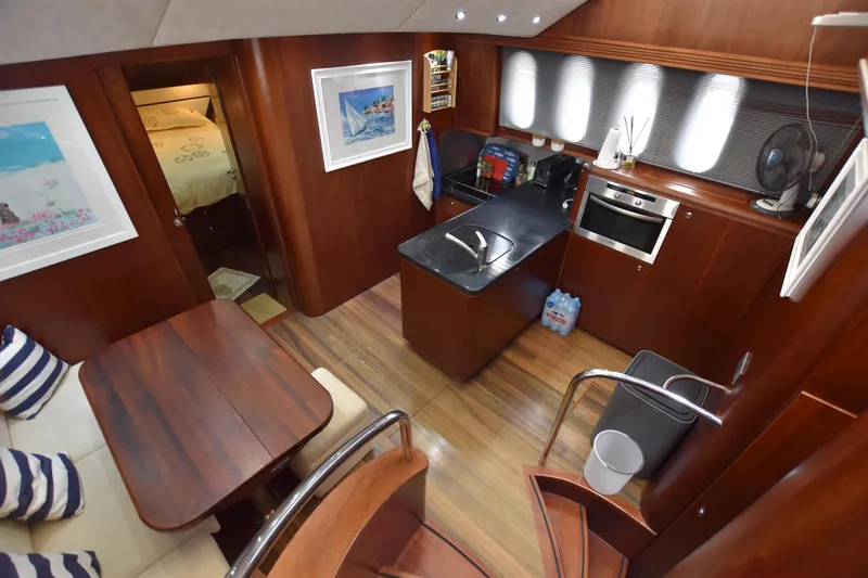 Vesuvio Yacht Photos Pics Luxurious 2007 Pacific Prestige 170 yacht interior with kitchen, dining area, and cozy cabin.