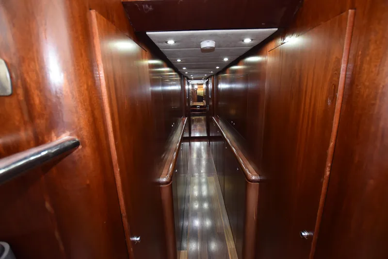 Vesuvio Yacht Photos Pics Narrow wooden hallway inside 2007 Pacific Prestige 170 yacht, featuring sleek design and ambient lighting.