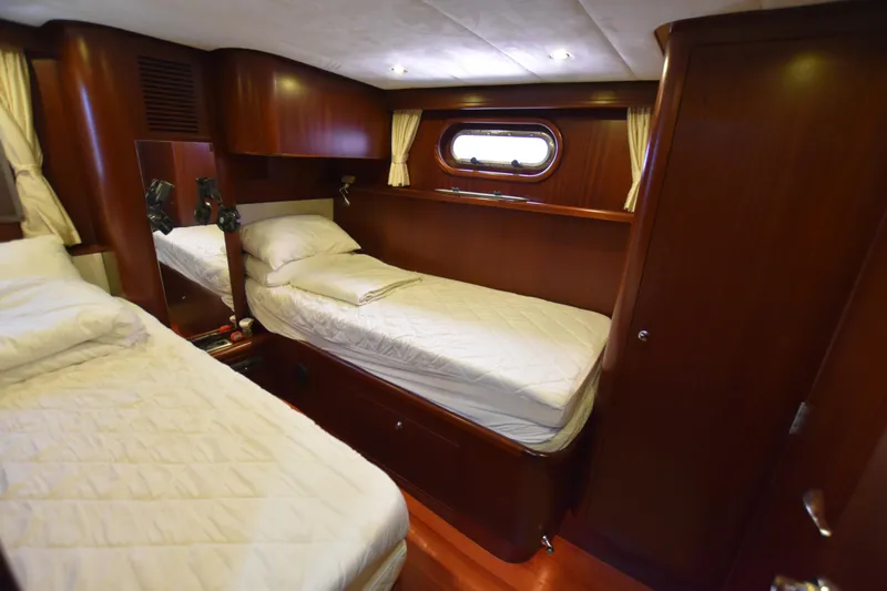 Vesuvio Yacht Photos Pics Luxurious cabin interior of 2007 Pacific Prestige 170 yacht with twin beds and wooden finish.