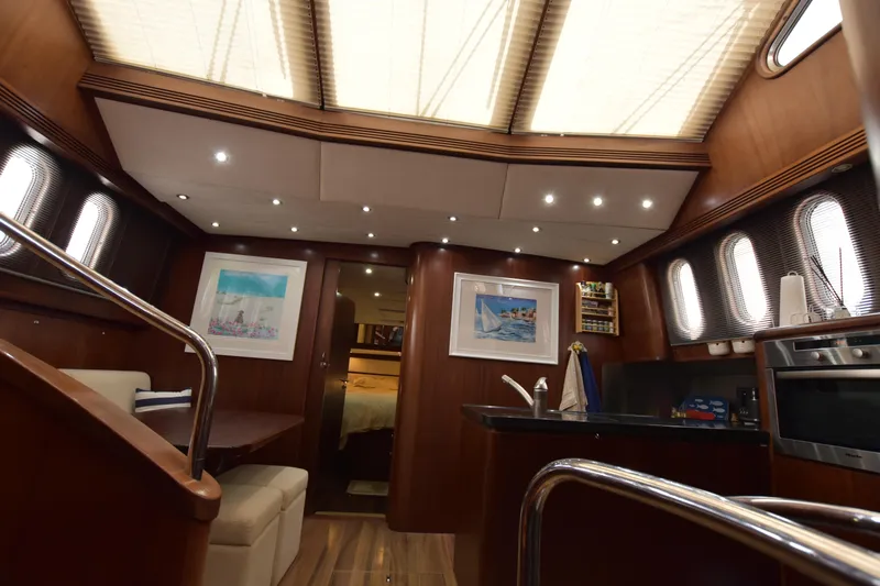 Vesuvio Yacht Photos Pics Luxurious interior of 2007 Pacific Prestige 170 yacht with elegant wood finish and modern amenities.