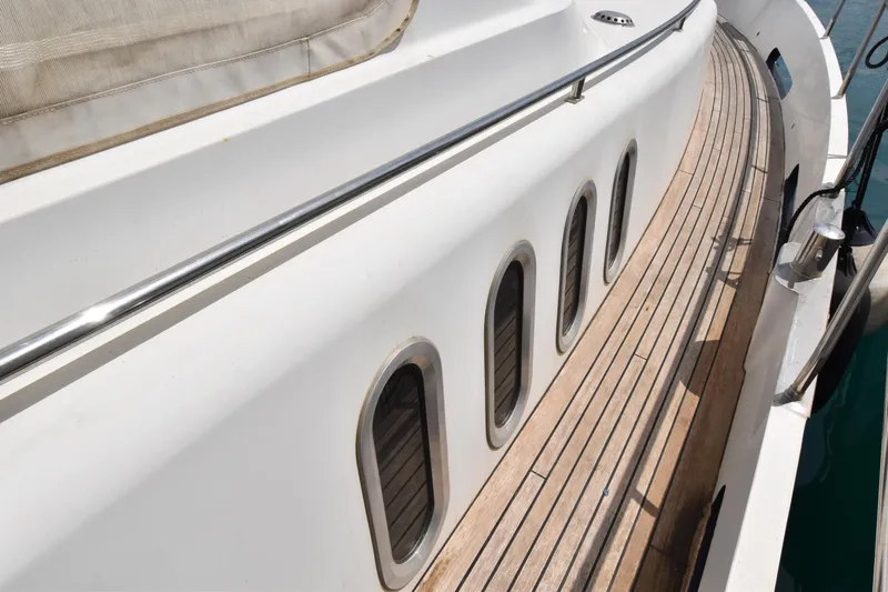 Vesuvio Yacht Photos Pics Side view of 2007 Pacific Prestige 170 yacht with wooden deck and porthole windows.