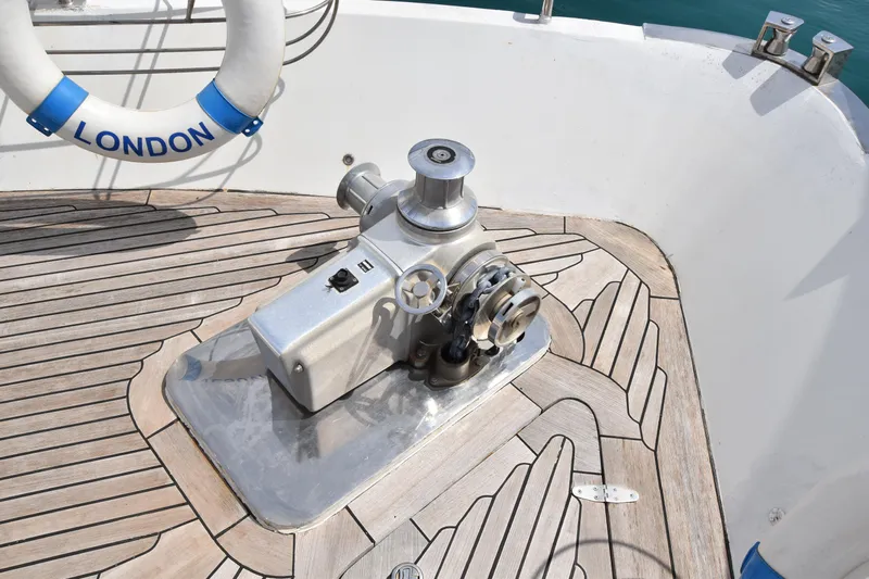 Vesuvio Yacht Photos Pics Windlass on Pacific Prestige 170 yacht deck, 2007 model, with wooden flooring and life ring.