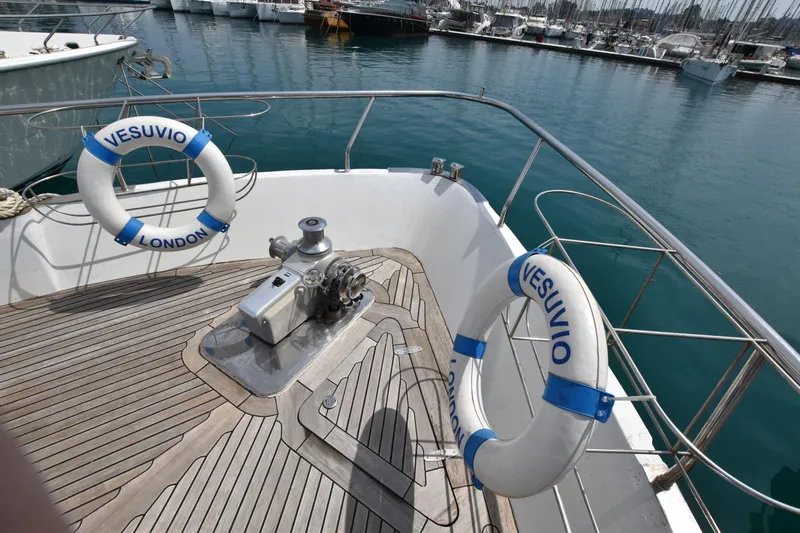 Vesuvio Yacht Photos Pics Deck of 2007 Pacific Prestige 170 yacht with lifebuoys, docked in marina.