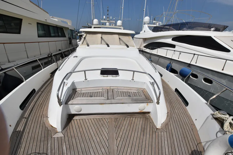 Vesuvio Yacht Photos Pics 2007 Pacific Prestige 170 yacht with wooden deck, docked among other boats.