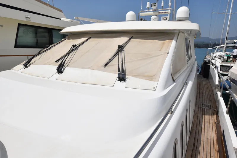 Vesuvio Yacht Photos Pics 2007 Pacific Prestige 170 yacht with covered windows and docked alongside other boats.