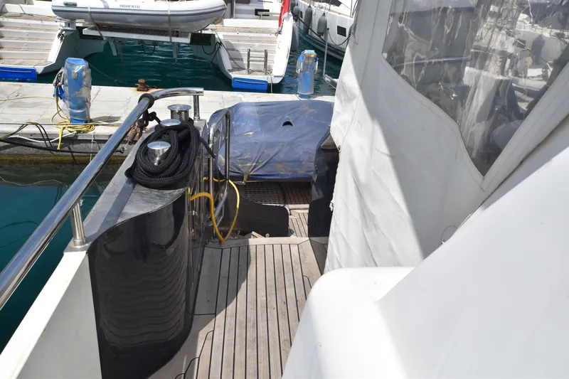 Vesuvio Yacht Photos Pics Side deck of a 2007 Pacific Prestige 170 yacht, docked at a marina.