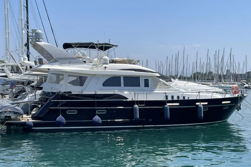 Vesuvio Yacht Photos Pics Luxury yacht Pacific Prestige 170, 2007 model, docked in a marina with clear blue skies.