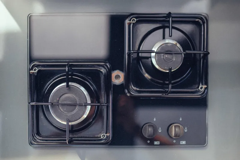 Hummingbird Yacht Photos Pics Two-burner black gas stove with control knobs, viewed from above.