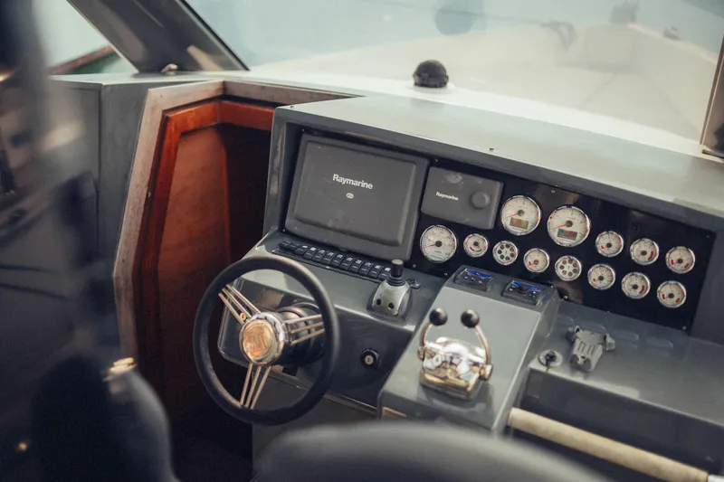 Hummingbird Yacht Photos Pics Control panel of a 2008 Fjord 40 Open boat with steering wheel and gauges.