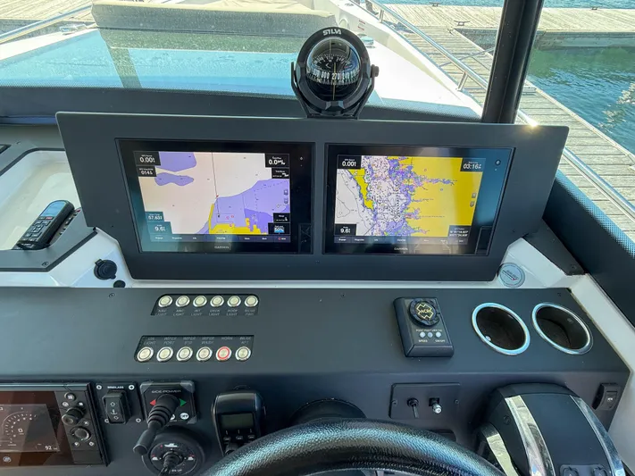 Essi Yacht Photos Pics Control panel of 2019 Axopar 37 Cabin with dual navigation screens and compass.
