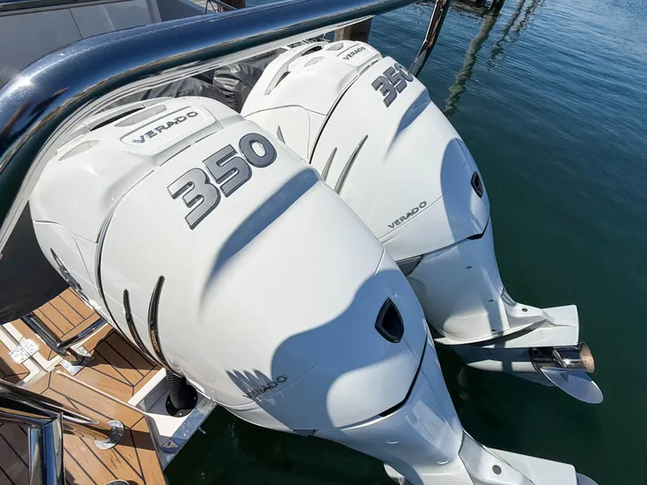 Essi Yacht Photos Pics Twin 350 Verado engines on a 2019 Axopar 37 Cabin boat, docked on calm water.