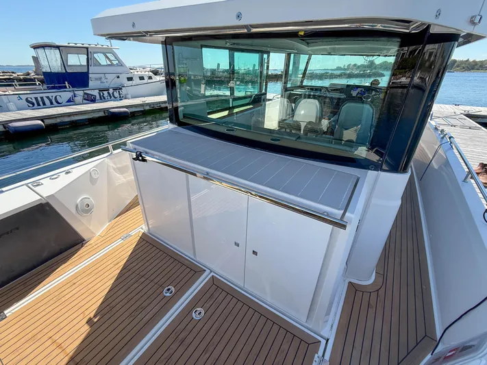 Essi Yacht Photos Pics 2019 Axopar 37 Cabin boat with sleek deck and modern design at marina.