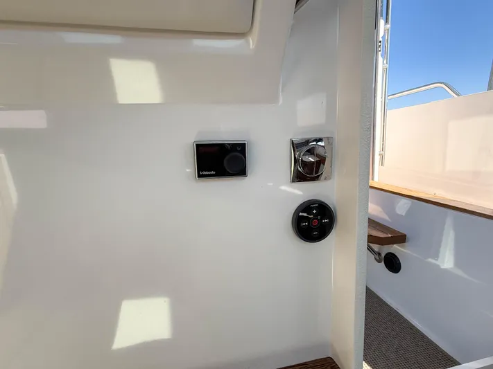 Essi Yacht Photos Pics 2019 Axopar 37 Cabin interior controls and seating area with natural light.