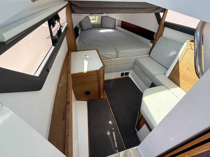 Essi Yacht Photos Pics 2019 Axopar 37 Cabin interior with bed and seating area.