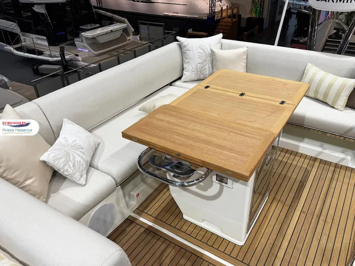  Yacht Photos Pics Luxurious seating area on 2025 Prestige F4.3 yacht with wooden table and cushions.