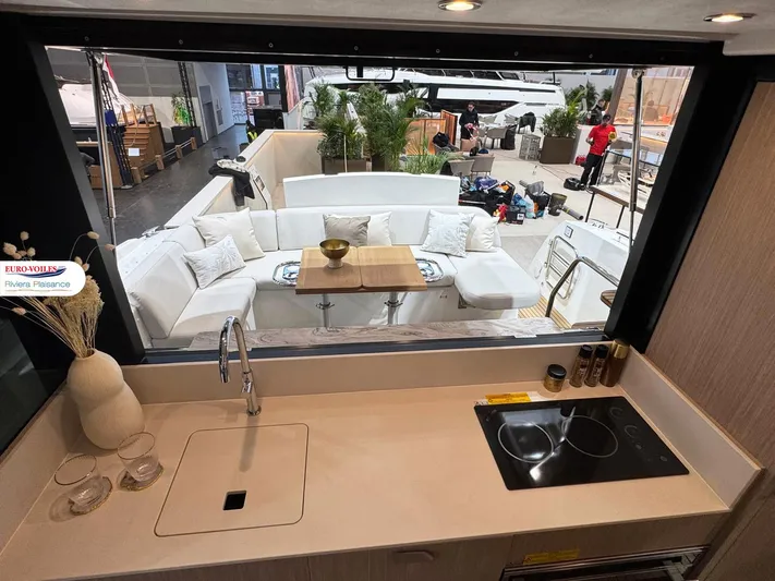  Yacht Photos Pics Modern yacht interior with kitchen view, Prestige F4.3, 2025 model, featuring sleek design and outdoor seating.