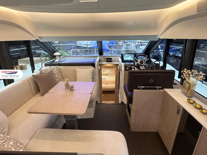  Yacht Photos Pics Luxurious interior of 2025 Prestige F4.3 yacht with elegant seating and modern helm station.