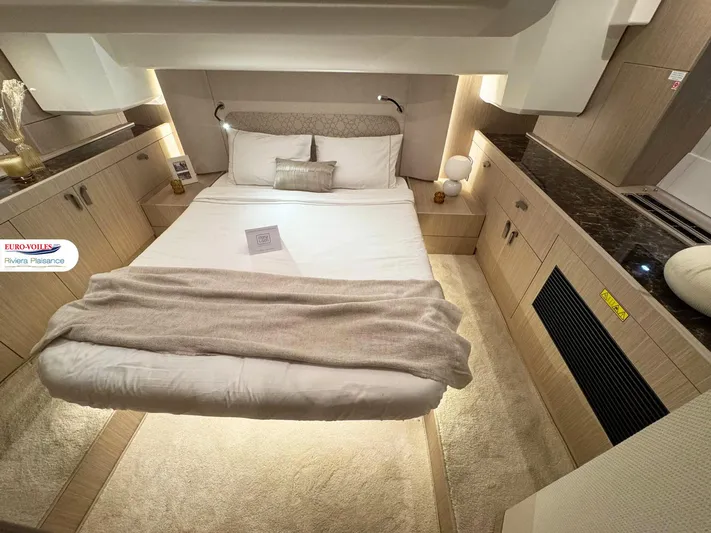  Yacht Photos Pics Luxurious cabin interior of a 2025 Prestige F4.3 yacht with cozy bedding and ambient lighting.