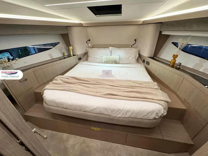  Yacht Photos Pics Luxurious bedroom interior of 2025 Prestige F4.3 yacht with elegant bedding and ambient lighting.