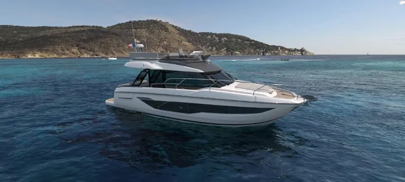  Yacht Photos Pics 2025 Prestige F4.3 yacht cruising in clear blue waters near a scenic coastline.