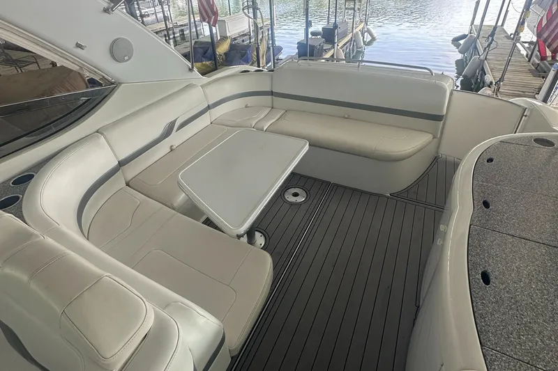  Yacht Photos Pics 2004 Formula 370 SS boat interior with spacious seating and table, docked by the water.