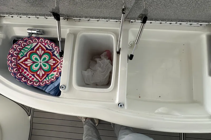  Yacht Photos Pics 2004 Formula 370 SS boat interior with storage compartments and colorful cushion.