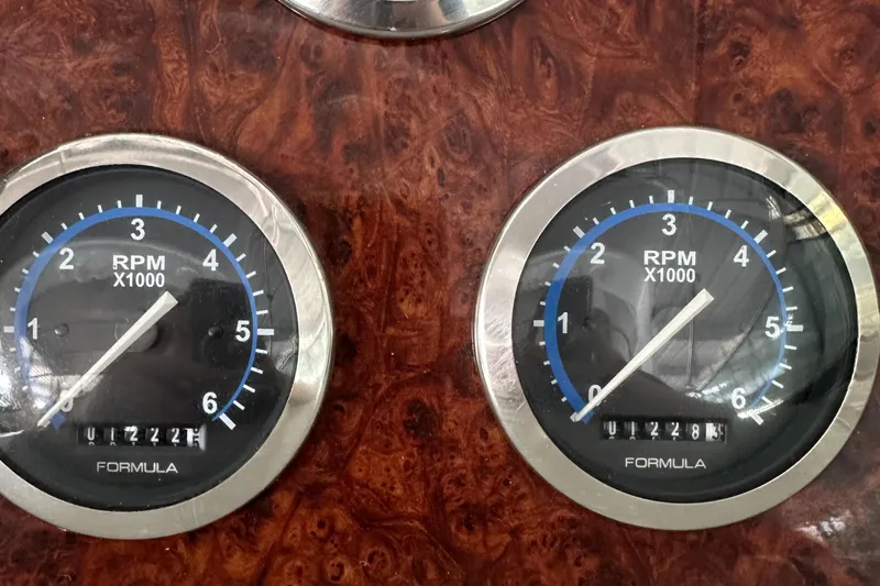  Yacht Photos Pics 2004 Formula 370 SS dashboard with dual RPM gauges on a wood grain panel.