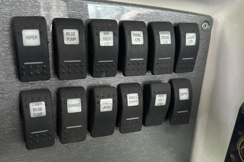  Yacht Photos Pics Control panel switches on a 2004 Formula 370 SS boat dashboard.