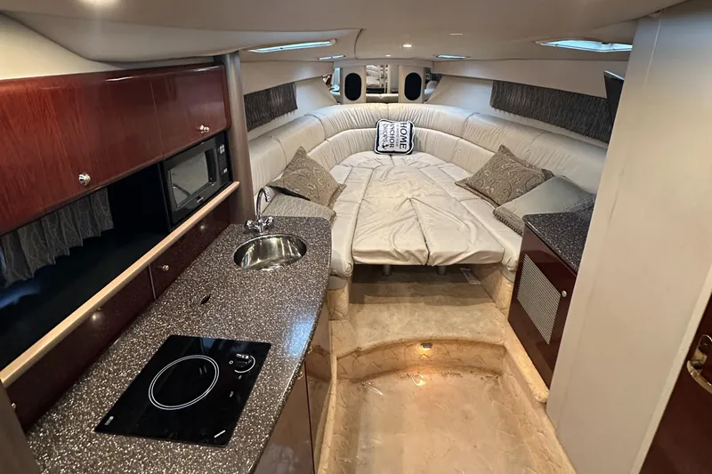 Yacht Photos Pics Luxurious interior of a 2004 Formula 370 SS boat with kitchenette and cozy seating.
