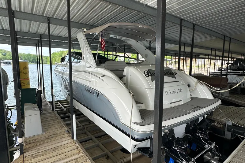  Yacht Photos Pics 2004 Formula 370 SS boat docked under a covered marina, rear view.