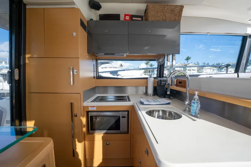 The Best Day Ever Yacht Photos Pics Modern kitchen interior on a 2013 Prestige 500S yacht, featuring sleek cabinetry and appliances.