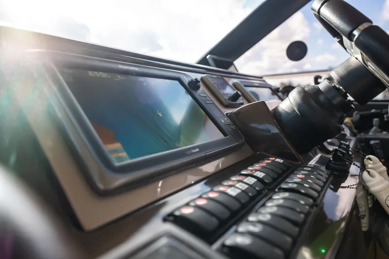 The Best Day Ever Yacht Photos Pics Control panel of a 2013 Prestige 500S yacht with navigation display and steering wheel.