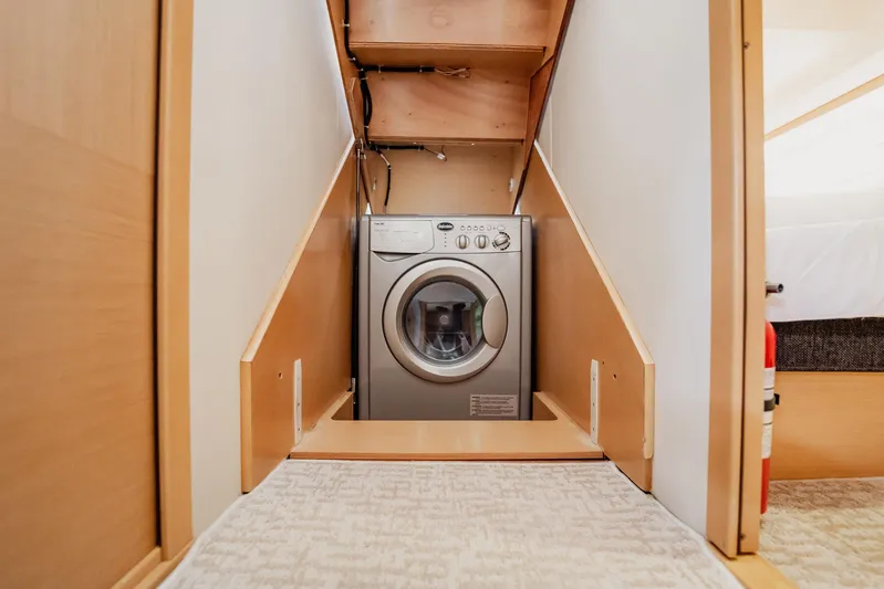 The Best Day Ever Yacht Photos Pics Laundry area inside 2013 Prestige 500S yacht, featuring a compact washing machine.