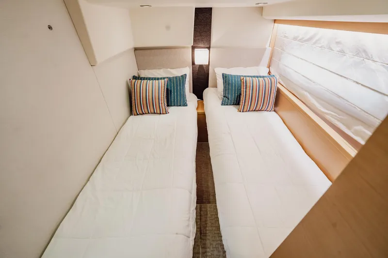 The Best Day Ever Yacht Photos Pics Twin beds with striped pillows in a 2013 Prestige 500S yacht cabin.