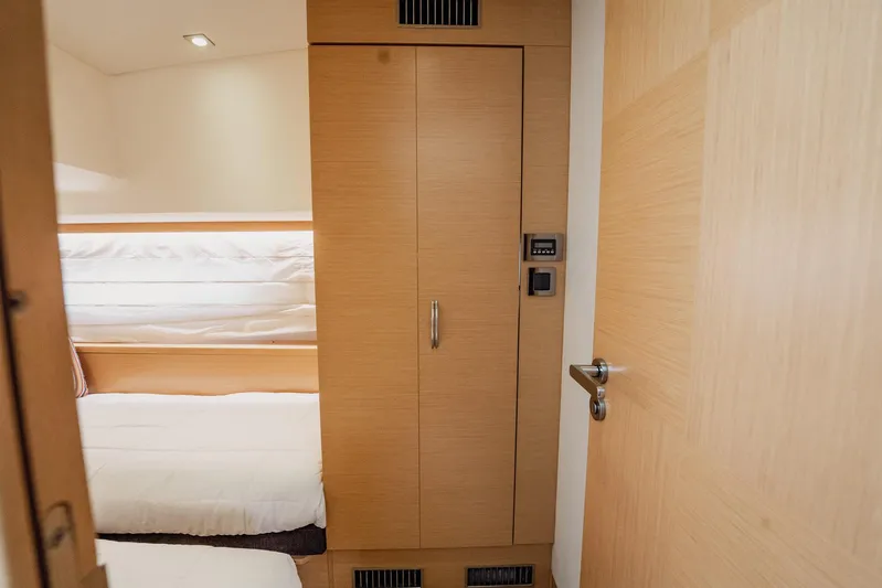 The Best Day Ever Yacht Photos Pics Interior of 2013 Prestige 500S yacht with wooden cabinetry and cozy bedding.