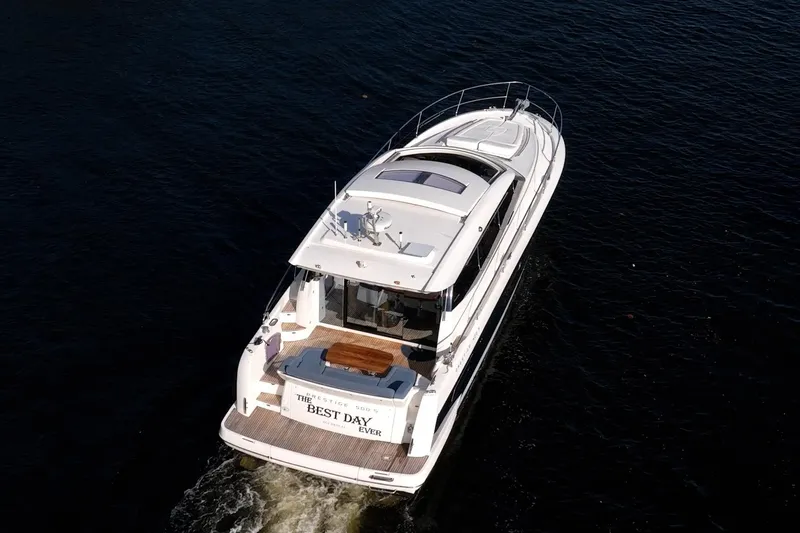 The Best Day Ever Yacht Photos Pics Aerial view of 2013 Prestige 500S yacht cruising on dark water.