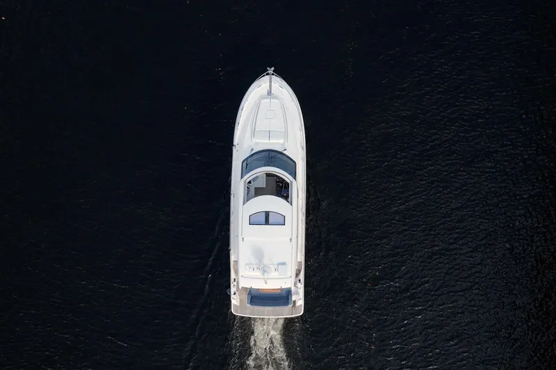 The Best Day Ever Yacht Photos Pics Aerial view of 2013 Prestige 500S yacht cruising on dark water.