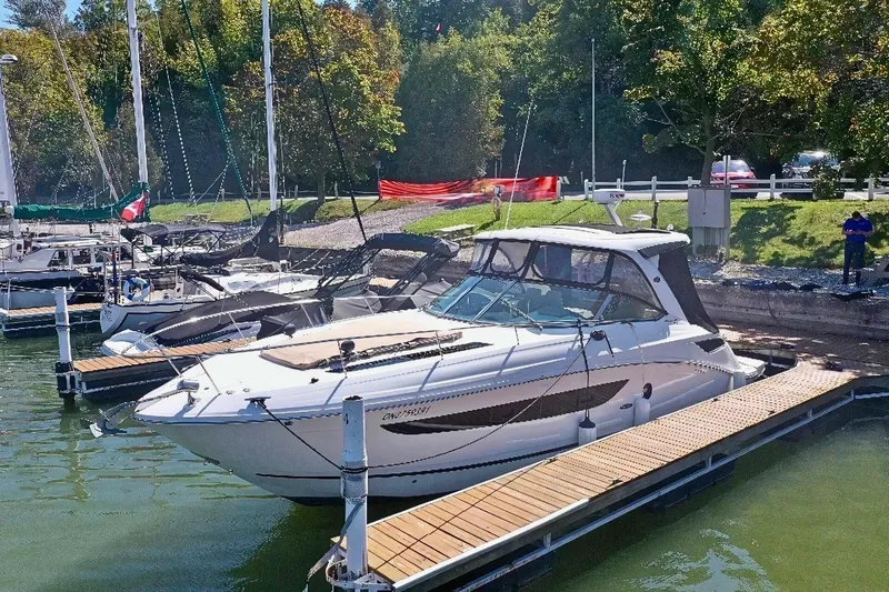  Yacht Photos Pics 2016 Sea Ray 350 Sundancer docked at marina, surrounded by lush greenery.