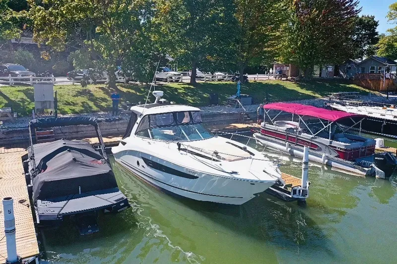  Yacht Photos Pics 2016 Sea Ray 350 Sundancer docked at a marina, surrounded by other boats.