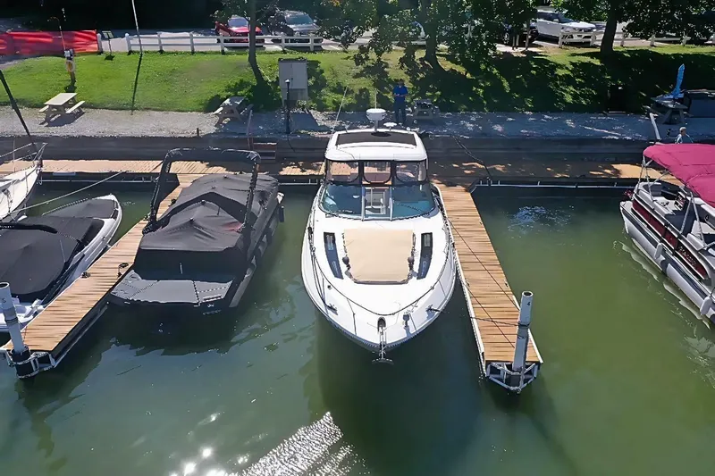  Yacht Photos Pics 2016 Sea Ray 350 Sundancer docked at a marina, surrounded by other boats.