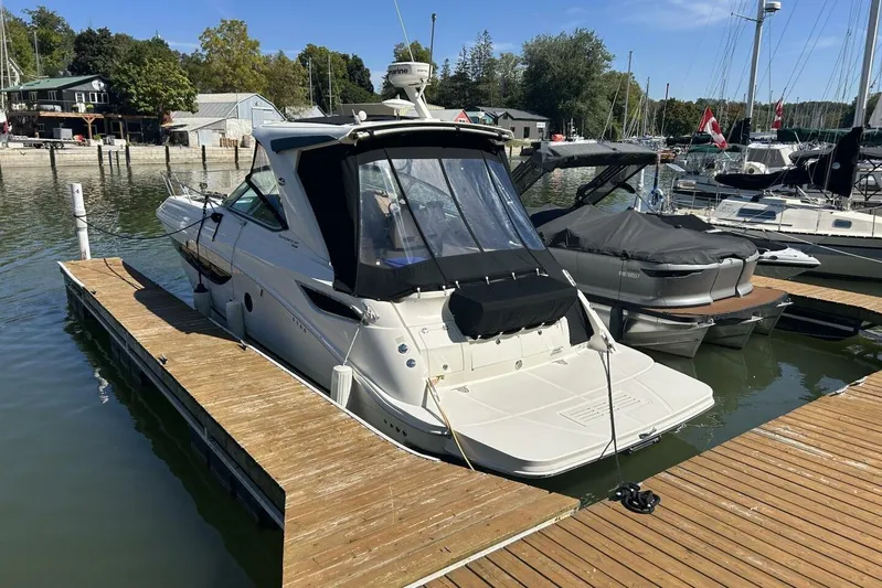  Yacht Photos Pics 2016 Sea Ray 350 Sundancer docked at a marina, surrounded by other boats.