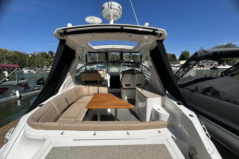  Yacht Photos Pics 2016 Sea Ray 350 Sundancer boat with spacious seating and table, docked at marina.