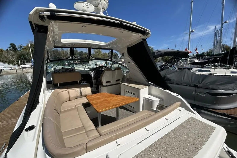 Yacht Photos Pics 2016 Sea Ray 350 Sundancer yacht with spacious seating and wooden table at marina.