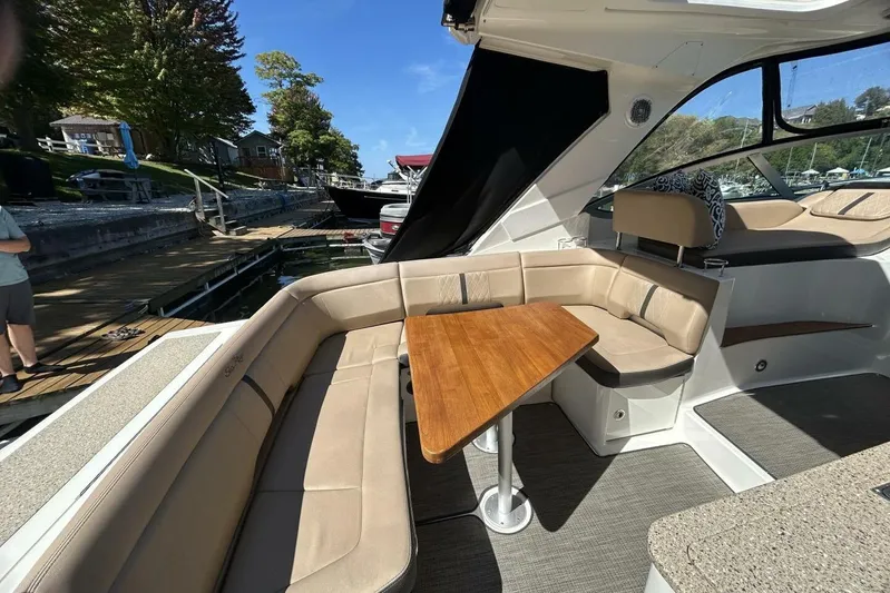  Yacht Photos Pics 2016 Sea Ray 350 Sundancer interior with beige seating and wooden table at dock.