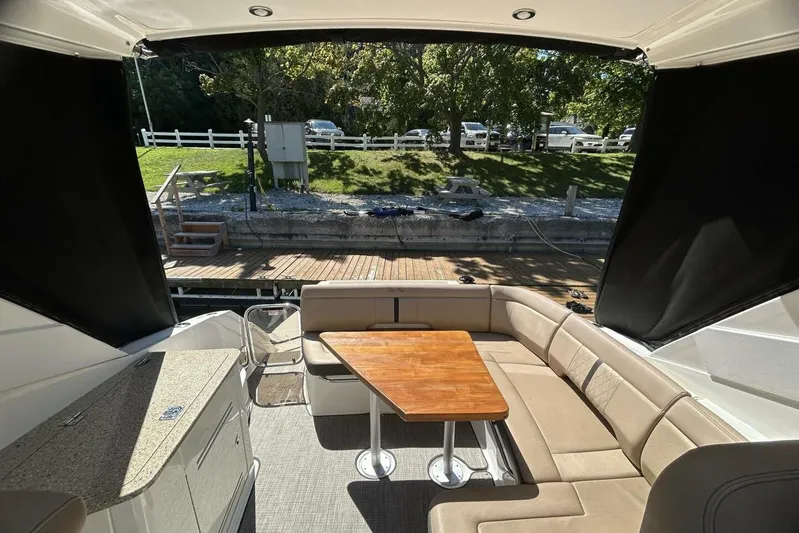  Yacht Photos Pics Interior of 2016 Sea Ray 350 Sundancer with seating and wooden table.