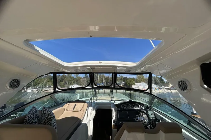  Yacht Photos Pics Interior view of 2016 Sea Ray 350 Sundancer yacht with open sunroof and dashboard.