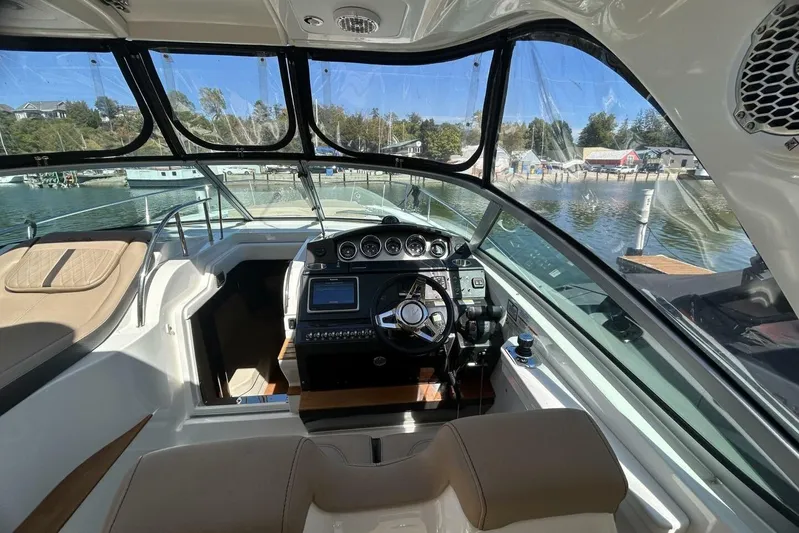  Yacht Photos Pics Interior view of 2016 Sea Ray 350 Sundancer yacht cockpit with steering wheel and dashboard.
