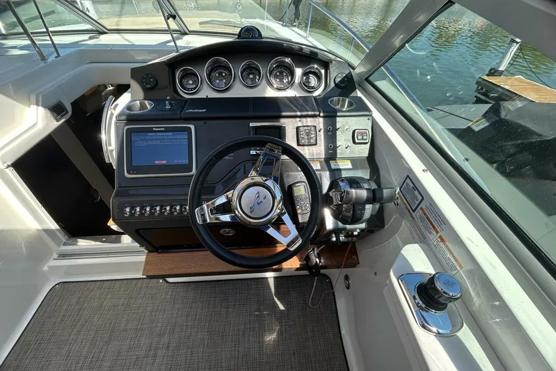  Yacht Photos Pics Cockpit of 2016 Sea Ray 350 Sundancer with steering wheel and control panel.