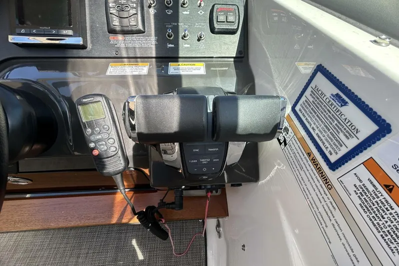  Yacht Photos Pics Control panel of a 2016 Sea Ray 350 Sundancer yacht with throttle and navigation controls.