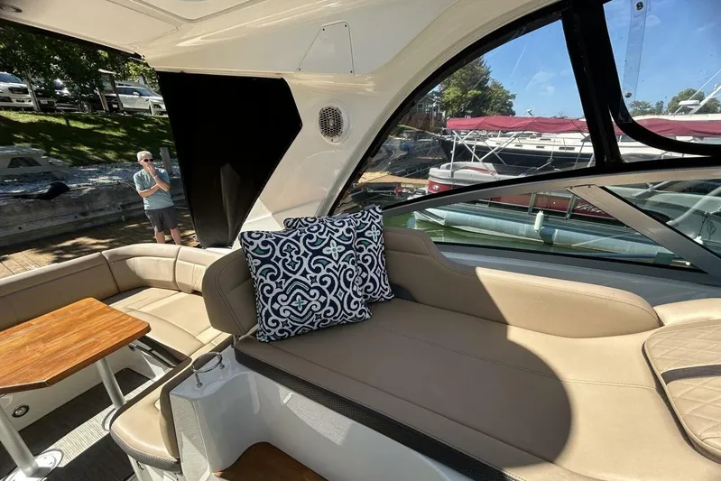  Yacht Photos Pics Interior of 2016 Sea Ray 350 Sundancer with beige seating and decorative pillow.